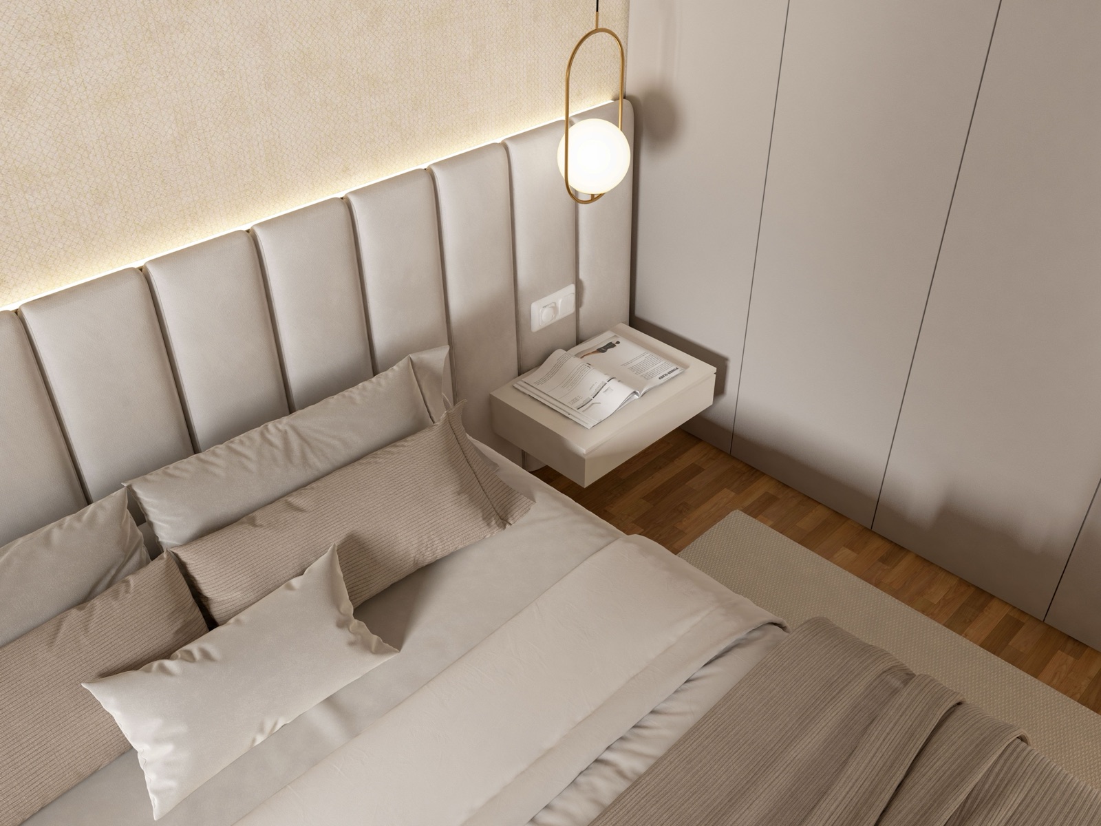 Detalle de dormitorio — cabecera tapizada con pendiente dorado